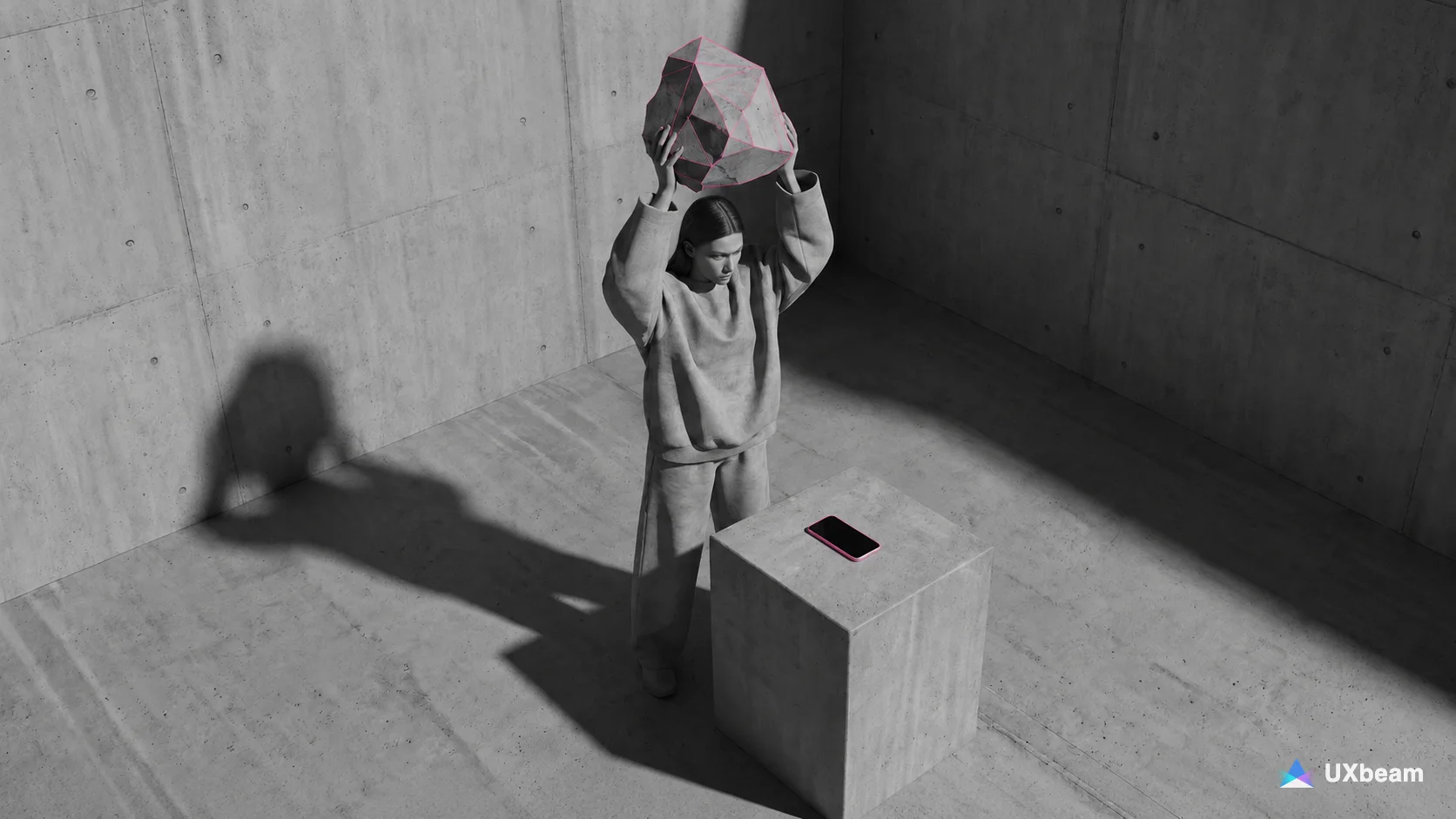 A woman in a bare concrete room lifts a large faceted rock overhead. A phone with a pink edge lies on a concrete pedestal beside her, and her shadow stretches across the wall.